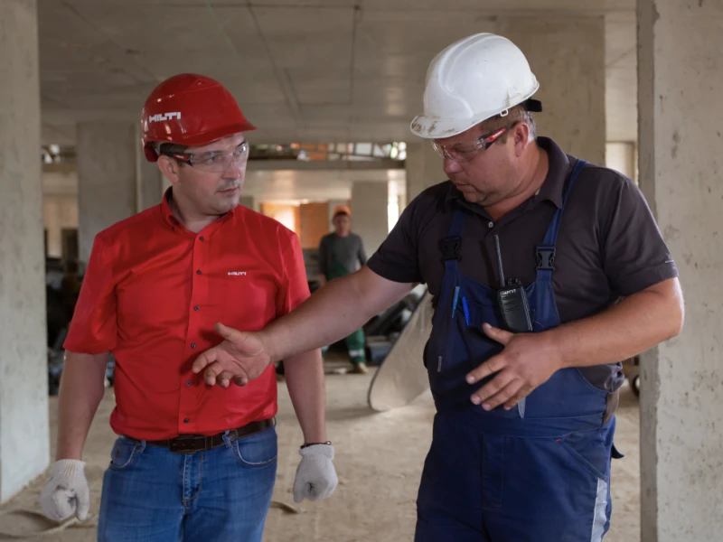Tow contractors talking at job site.
