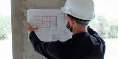 Contractor looking at basement blueprints.