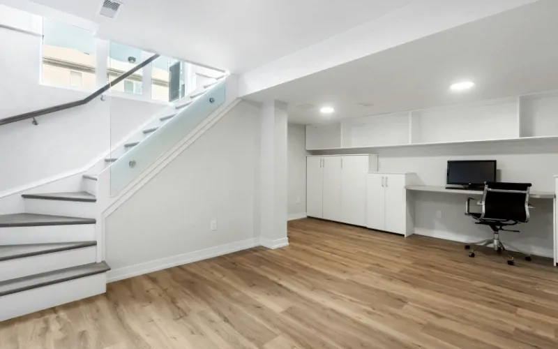 A finished basement for a modern office with plenty of light.
