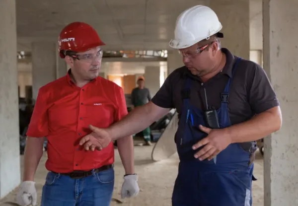 Tow contractors talking at job site.